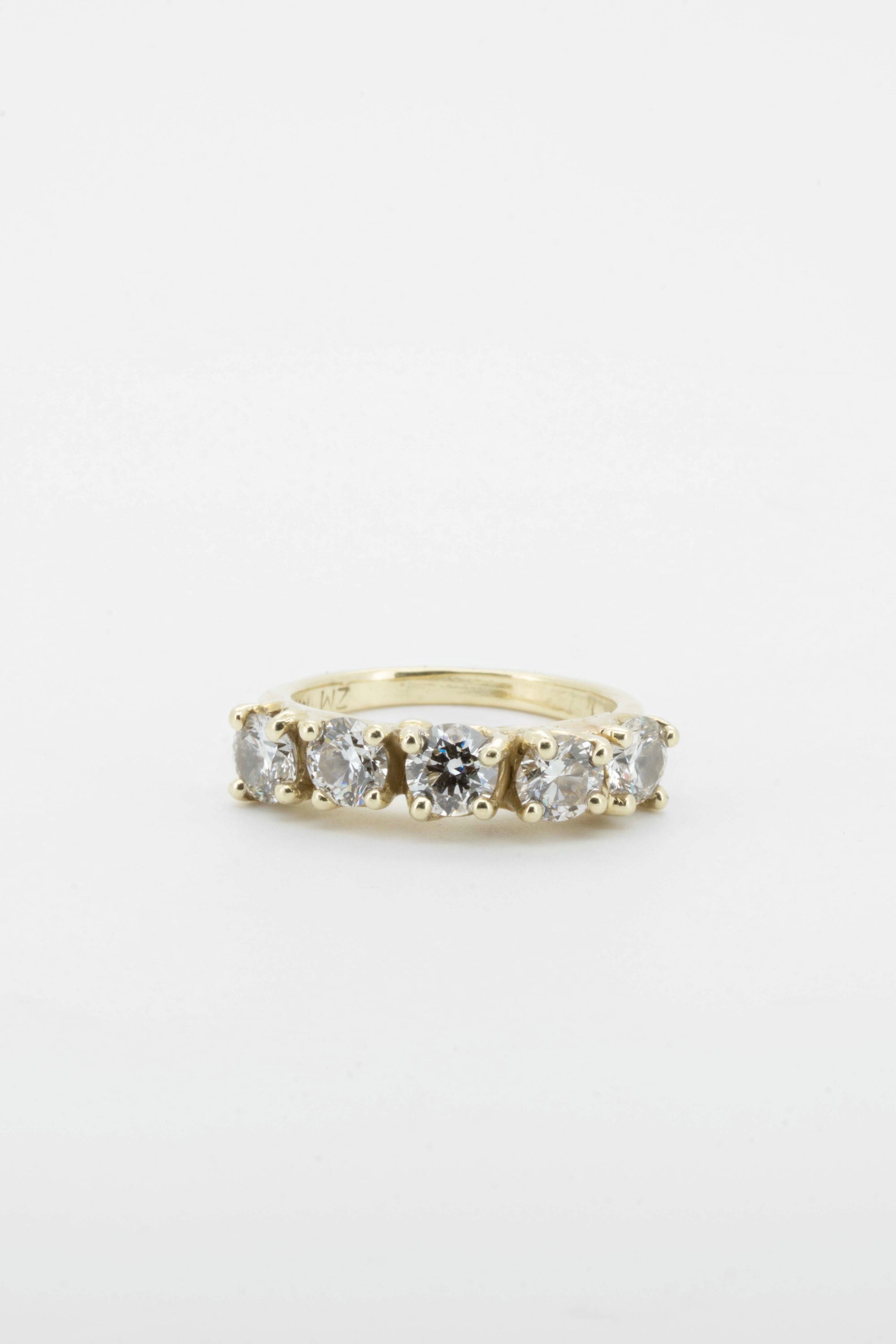 five brilliant diamonds set in solid 14 carat yellow gold