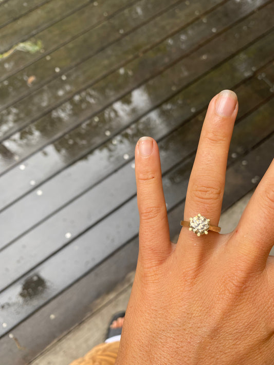 Champagne diamond ring glowing on finger