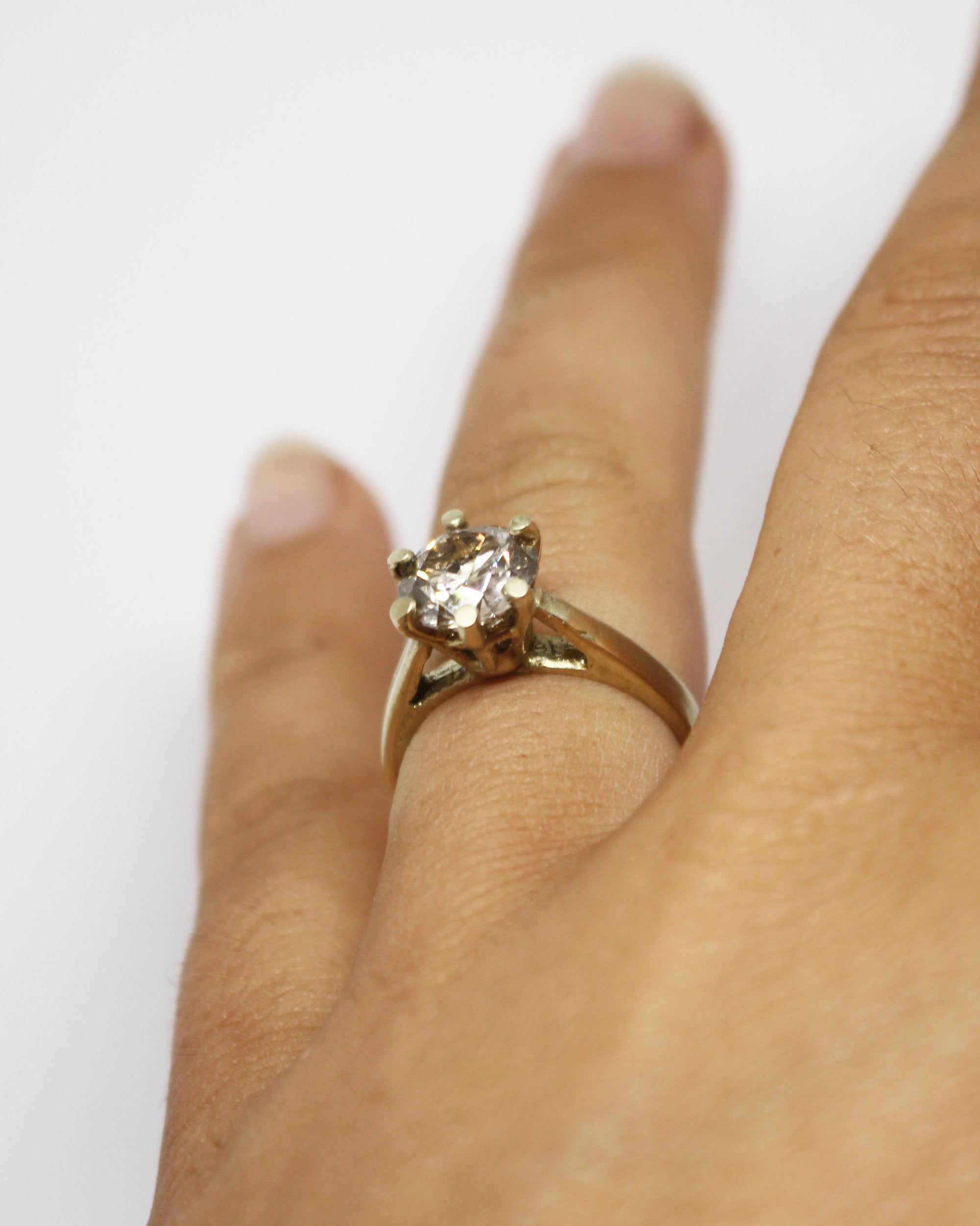 champagne diamond and 14ct yellow gold ring photographed on finger